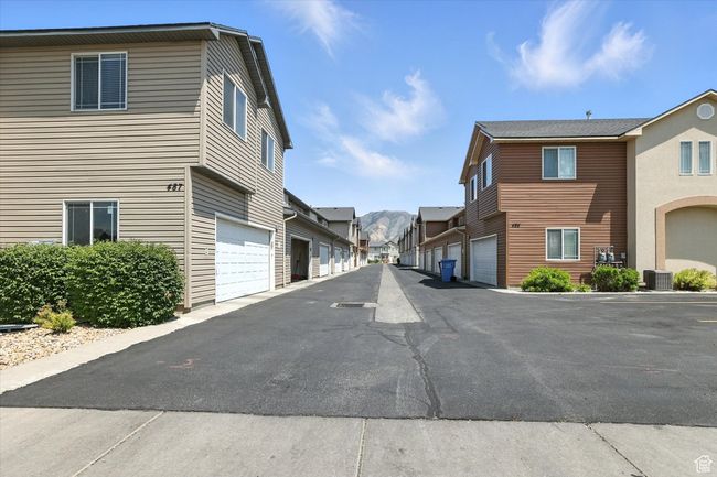View of asphalt road featuring a residential view | Image 33