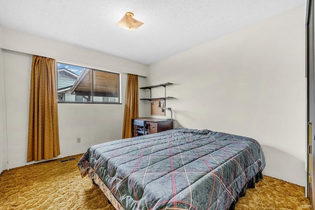 Carpeted bedroom featuring a textured ceiling | Image 15