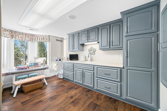 laundry room featuring a sink, visible vents, gray cabinetry, light countertops, and dark wood-type flooring | Image 55