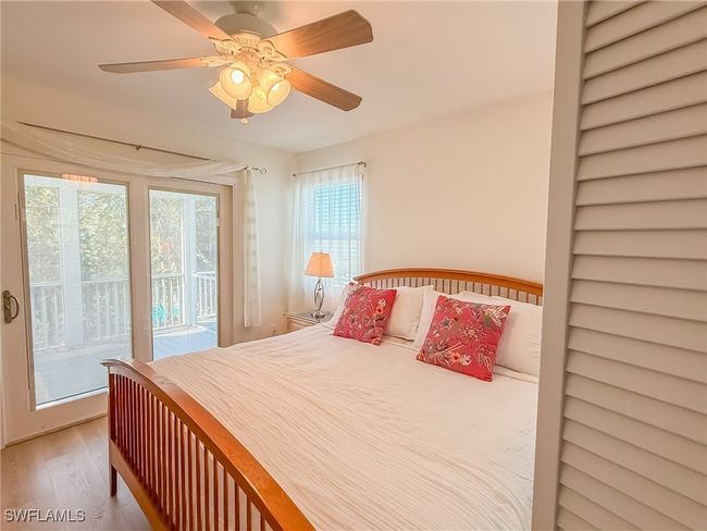 Bedroom with access to outside, ceiling fan, and wood finished floors | Image 34
