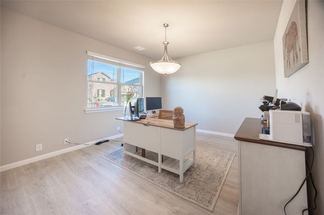 Home office with light wood-type flooring | Image 4
