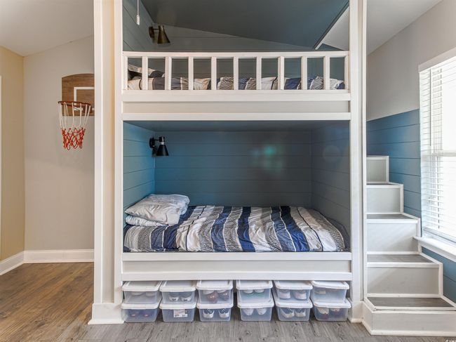 Bedroom featuring hardwood / wood-style flooring, vaulted ceiling, and multiple windows | Image 25