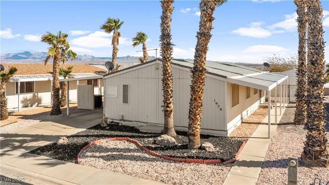 View of home's exterior featuring a carport, fence, a mountain view, and cooling unit | Image 61