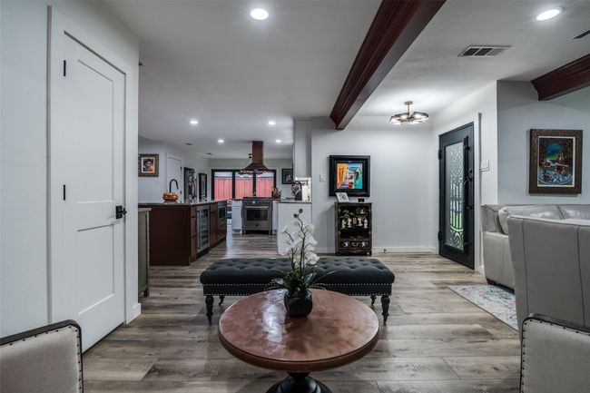 Living area with recessed lighting, light wood-type flooring, beverage cooler, and bar area | Image 9
