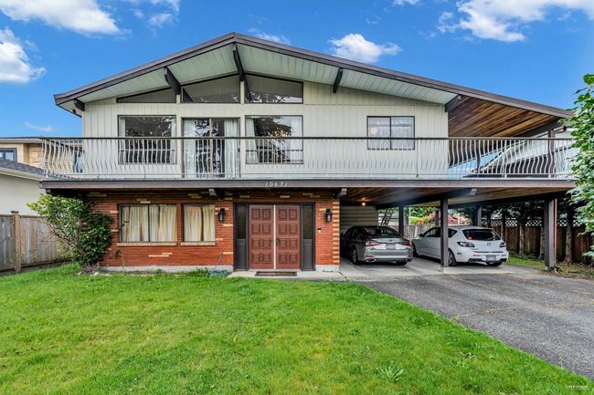 View of front of home with a carport, asphalt driveway, and brick siding | Image 20
