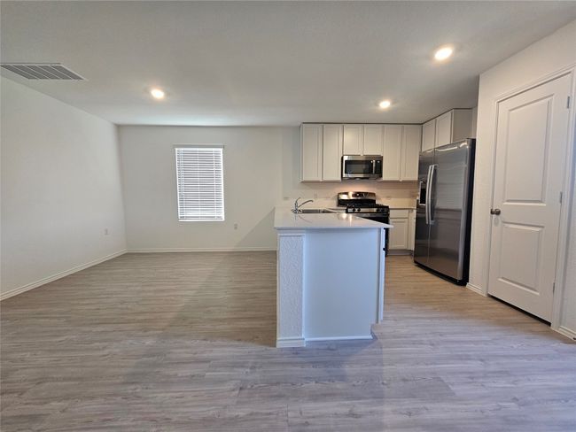 Kitchen with visible vents, stainless steel appliances, light wood-type flooring, and recessed lighting | Image 5