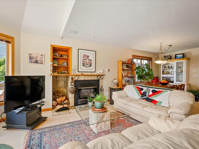 Living area with a fireplace and built in shelves | Image 4