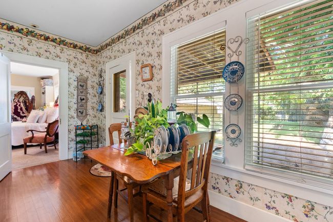 Dining area featuring wood finished floors and wallpapered walls | Image 17