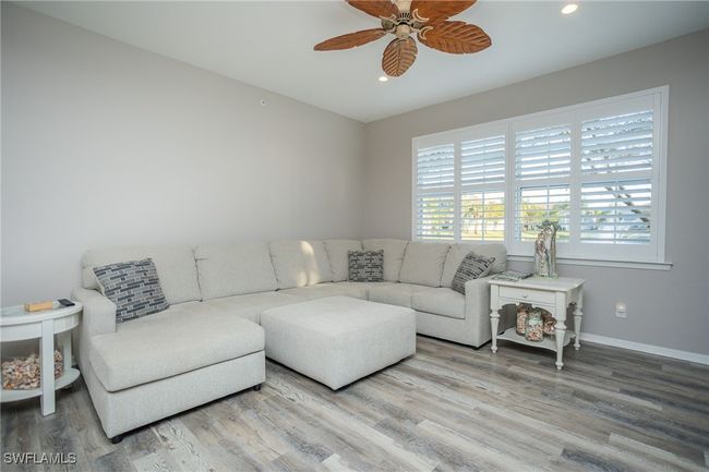 Living room featuring a ceiling fan, recessed lighting, baseboards, and vinyl wood finished floors | Image 4