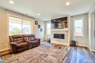 Open living concept with gas fireplace and luxury vinyl plank flooring throughout. | Image 3