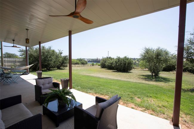 View of patio featuring ceiling fan and outdoor lounge area | Image 32