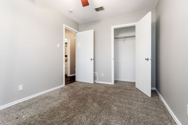 Unfurnished bedroom featuring carpet floors, a closet, and a ceiling fan | Image 23
