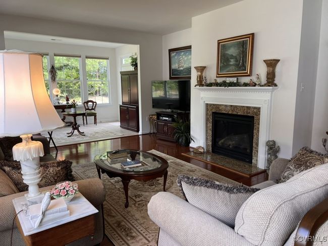 Living room with wood-type flooring and a premium fireplace | Image 25