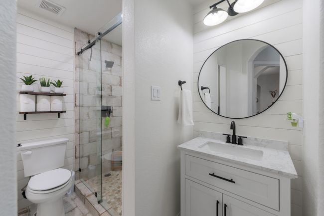 Full bathroom featuring toilet, vanity, and a stall shower | Image 27