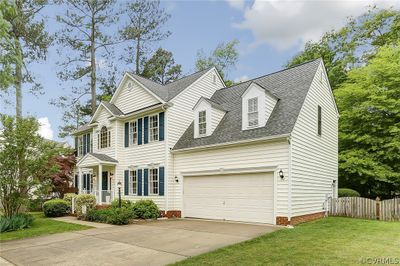 View of front facade featuring a front lawn and a garage | Image 1