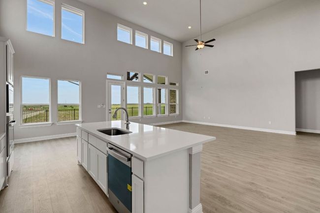 Kitchen with light wood-type flooring, dishwasher, open floor plan, ceiling fan, and recessed lighting | Image 8