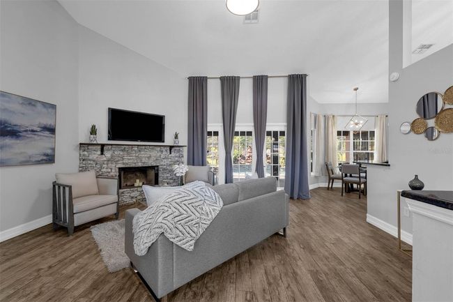 Living Room holds the Fireplace with attractive stone accents | Image 15