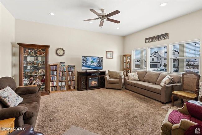 Living room with carpet, ceiling fan, recessed lighting, and a glass covered fireplace | Image 4