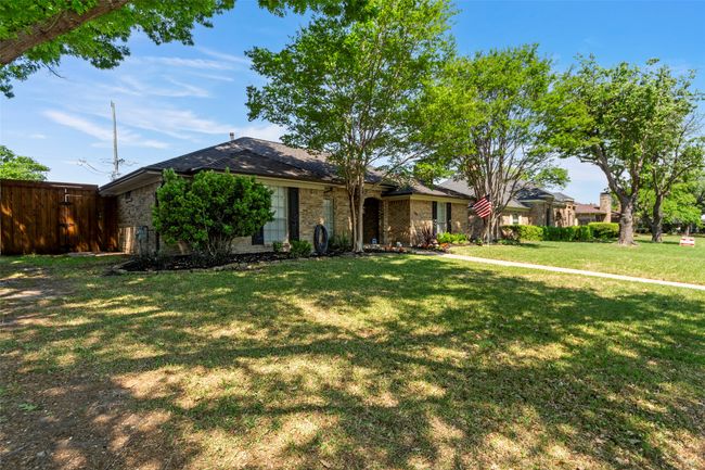 Single story home with brick siding, fence, and a front yard | Image 36