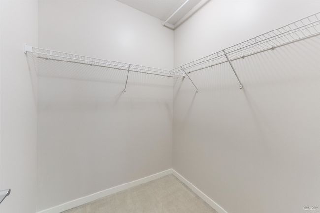 Spacious closet with light colored carpet | Image 15