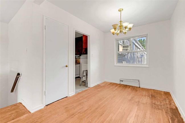Unfurnished dining area with a chandelier and wood finished floors | Image 10