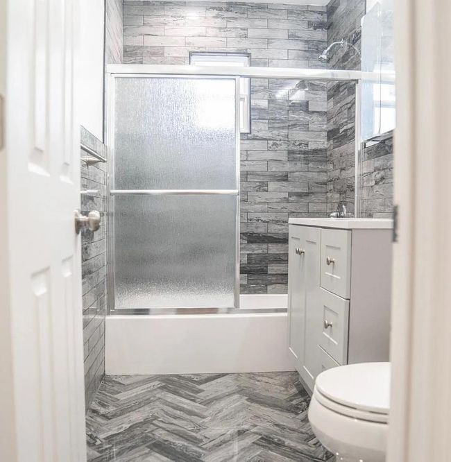 Full bath featuring vanity, toilet, and shower / bath combination with glass door | Image 7