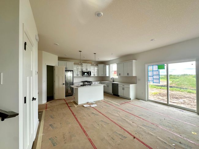 (Photo of a decorated model, actual homes finishes will vary) Cozy up next to the fireplace in your new Great Room! | Image 10
