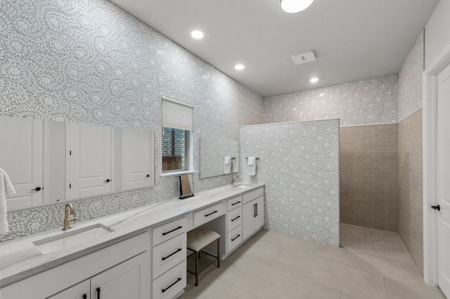 Luxurious bathroom featuring double vanity, a walk in shower, tile patterned floors, recessed lighting, and tile walls | Image 21