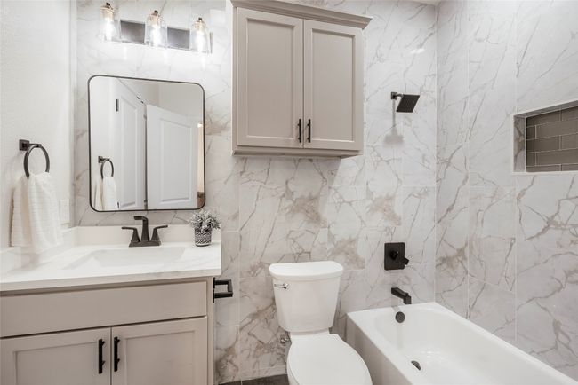Full bathroom with vanity, tub / shower combination, and tile walls | Image 20