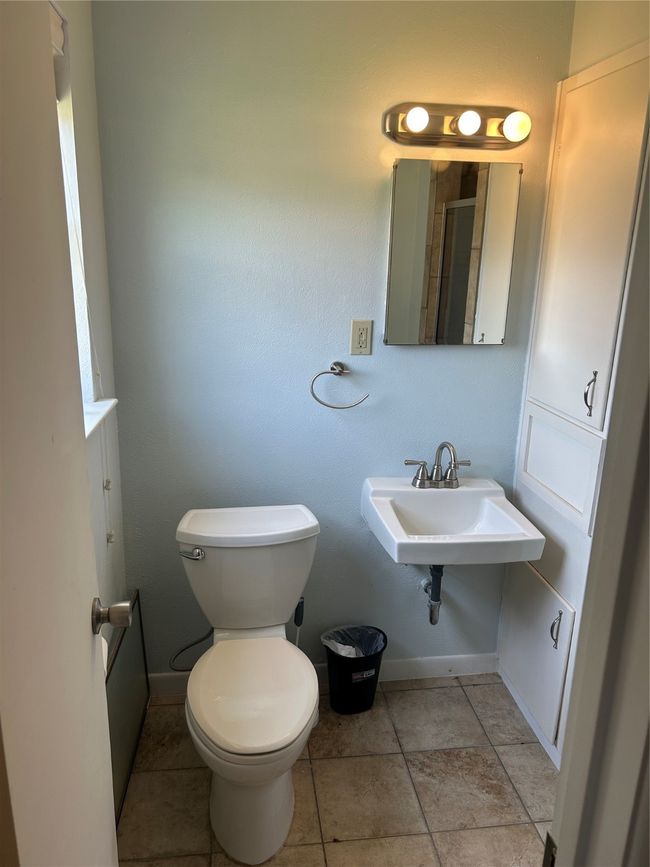 Bathroom featuring toilet, baseboards, and a sink | Image 11