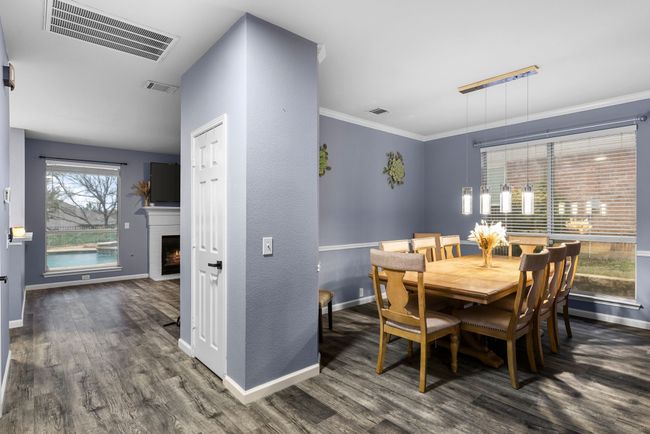 Dining room featuring dark wood-type flooring and ornamental molding | Image 10