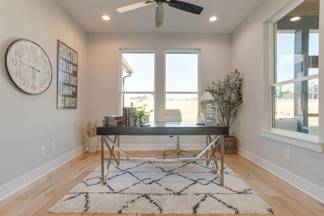 Office space with light wood-type flooring and ceiling fan | Image 16