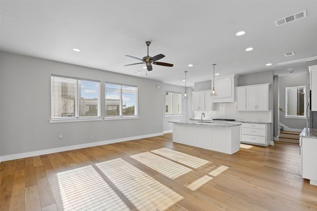 Kitchen featuring a sink, ceiling fan, light wood-style flooring, baseboards, and recessed lighting | Image 9