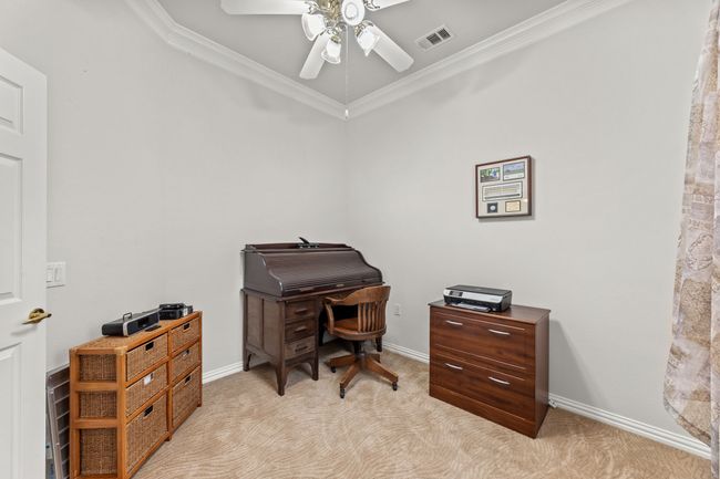 Office area featuring crown molding, light carpet, a ceiling fan, and baseboards | Image 8