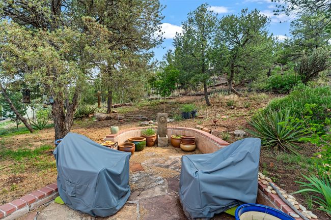 Fully fenced back yard with stone patio area | Image 40