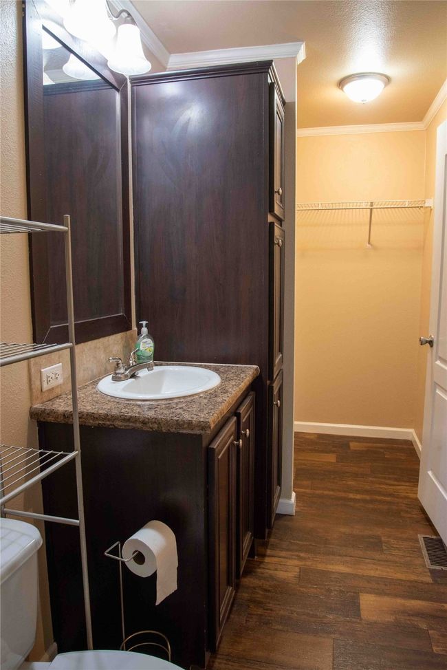 Master Bathroom with crown molding, vanity, visible vents, toilet, and wood finished floors | Image 30