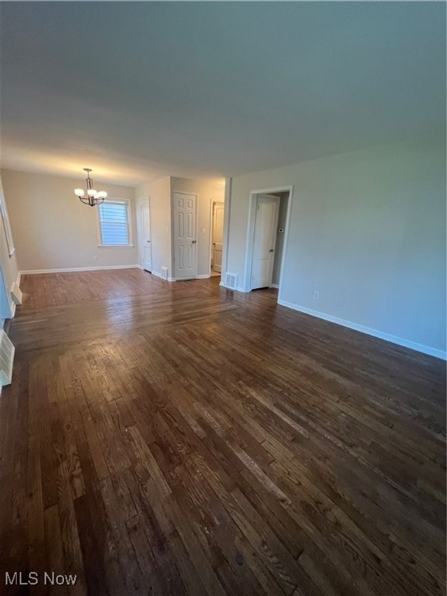 Livingroom and Dining Room featuring dark hardwood / wood- flooring and a chandelier | Image 10