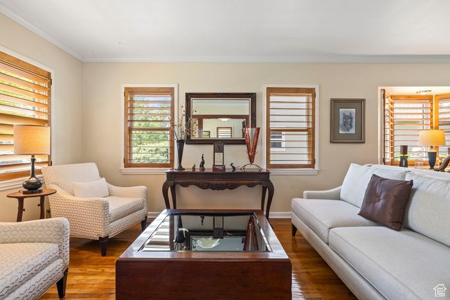 Living room with wood finished floors, crown molding, and plenty of natural light | Image 8