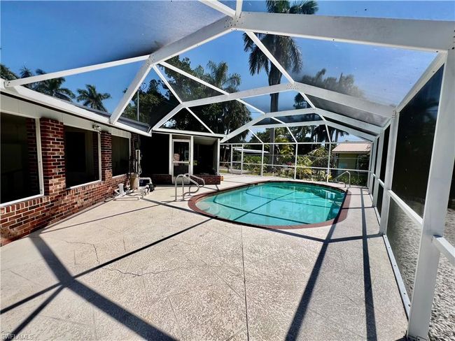 Outdoor pool with a lanai and a patio area | Image 4