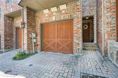 The entry doorway is to the left of the garage. | Image 1