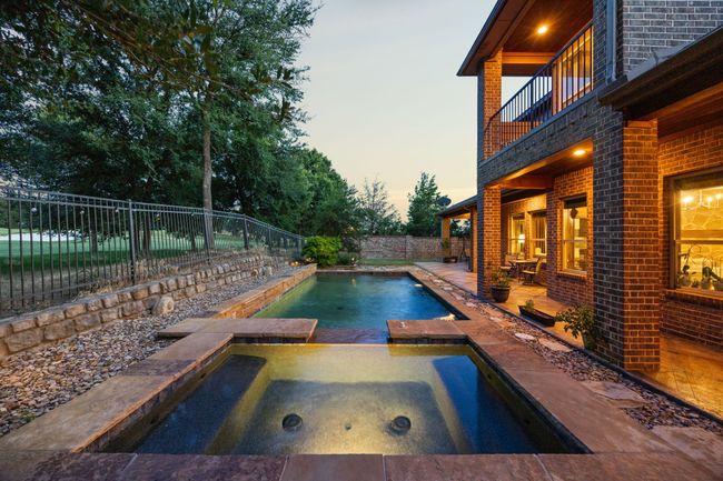 View of swimming pool with a fenced backyard | Image 37