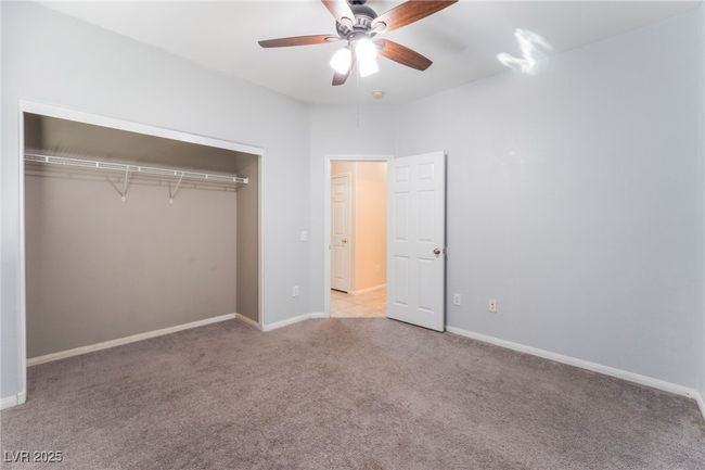 Unfurnished bedroom featuring light carpet, a closet, baseboards, and ceiling fan | Image 35