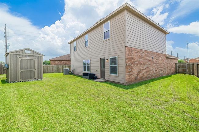 Step outside to a large backyard complete with a 12x8 storage shed, perfect for outdoor projects or extra storage. | Image 23