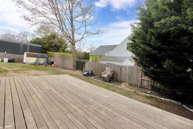 Wooden terrace with a fenced backyard, an outbuilding, and a storage shed | Image 25