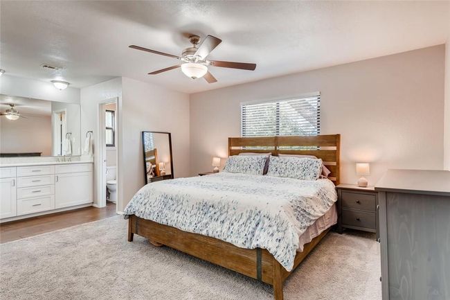 Bedroom with light carpet, a ceiling fan, and ensuite bath | Image 14
