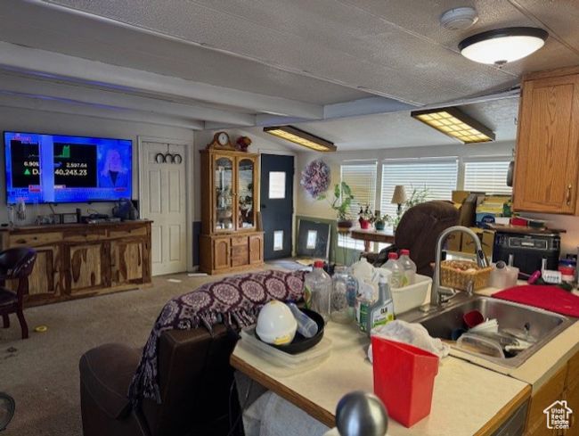 Dining space featuring carpet floors and beam ceiling | Image 4