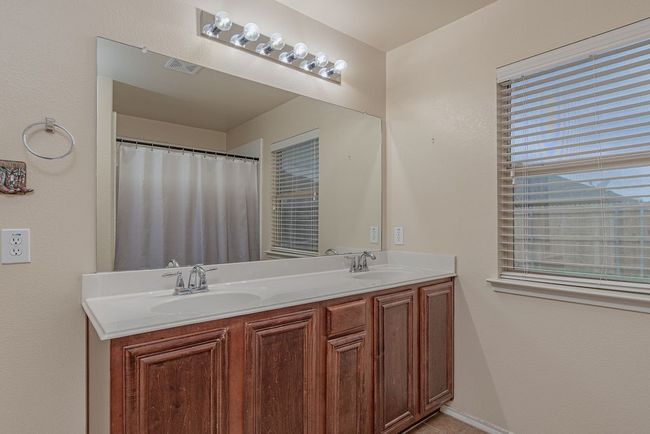 Full bath with double vanity, visible vents, and a sink | Image 17