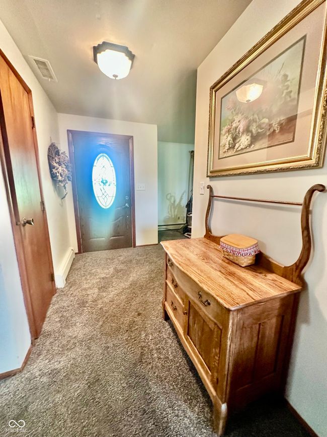 carpeted entrance foyer featuring baseboards | Image 19