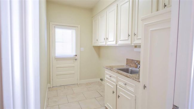 Laundry room leading to backyard | Image 8