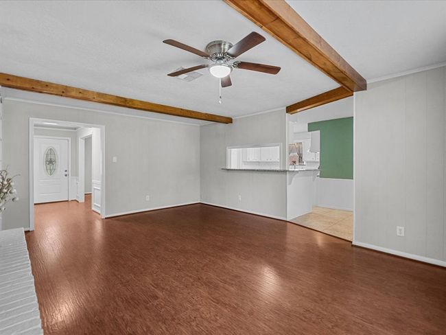 Another angle of main living room with Breakfast bar area leading into kitchen. | Image 5
